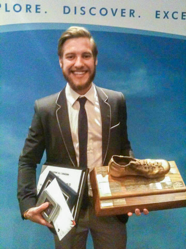 Photo of Stephen Ewashko with the golden boot for the VIU Mariners and other awards.
