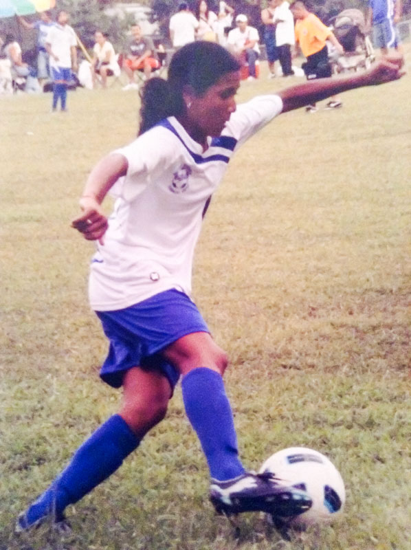 Photo of young Stephanie Quintanilla dribbling with the soccer ball.